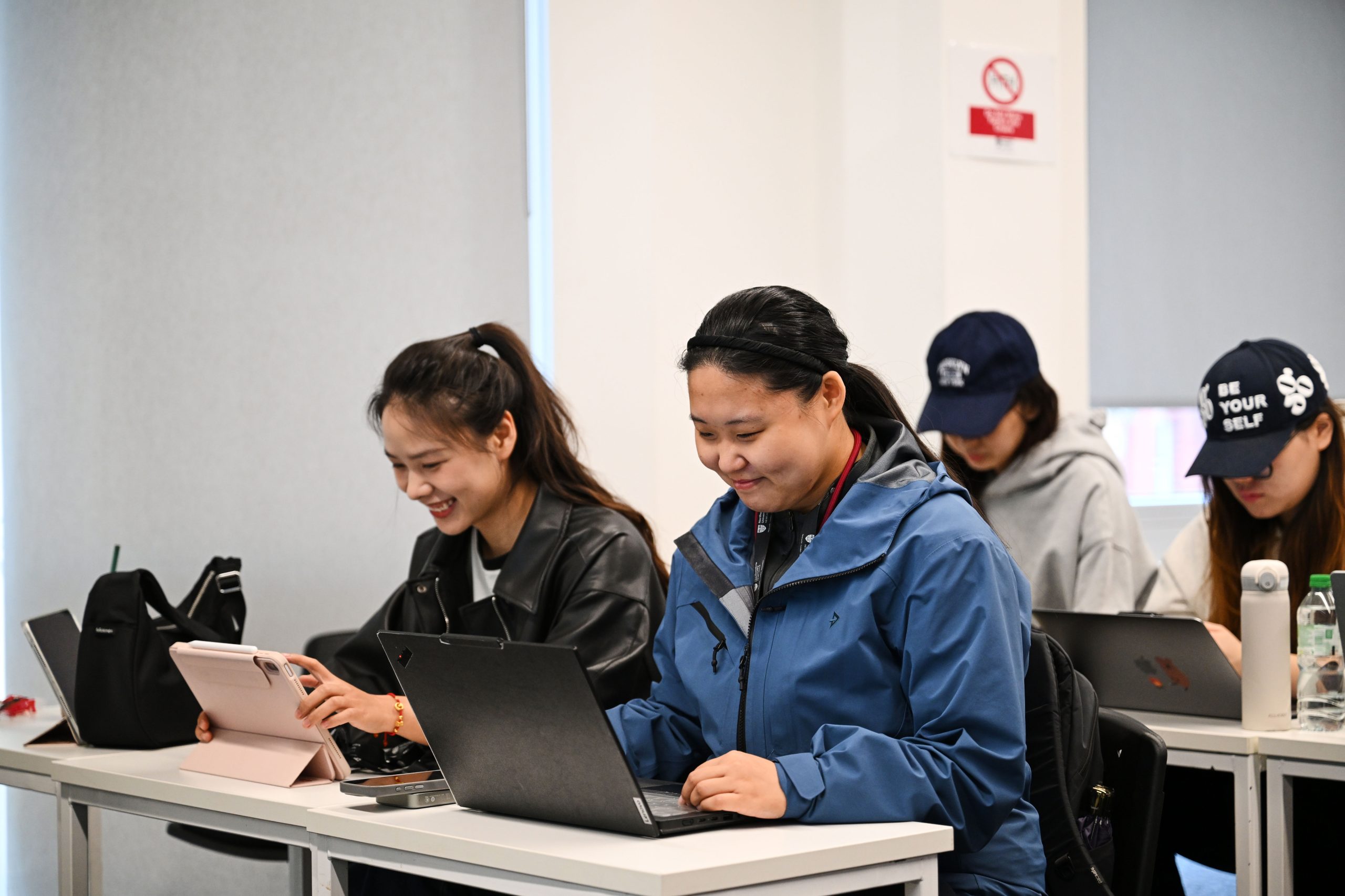 Students sat with laptops in a class